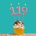 Birthday card with number 119 candle on aquamarine background