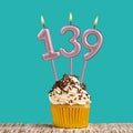 Birthday card with number 139 candle on aquamarine background Royalty Free Stock Photo