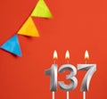 Birthday card - Number 137 candle in red background Royalty Free Stock Photo
