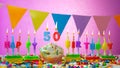 Birthday card with number 50 year. Happy birthday to a five ten year old. Candles burn with a festive cream cake. Greeting card Royalty Free Stock Photo