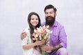 Birthday celebration. Man tulips bouquet. Father giving tulips girl. Dad with flowers. International womens day. Flower Royalty Free Stock Photo