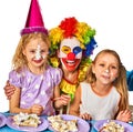 Birthday child clown eating cake with boy together. Kid with messy face. Royalty Free Stock Photo