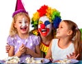 Birthday child clown eating cake with boy together. Kid with messy face. Royalty Free Stock Photo