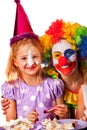 Birthday child clown eating cake with boy together. Kid with messy face. Royalty Free Stock Photo