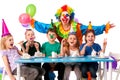 Birthday child clown playing with children. Kid holiday cakes celebratory.