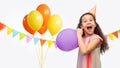 funny girl in birthday party hat blowing balloon Royalty Free Stock Photo