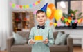 smiling boy in party hat with birthday cake Royalty Free Stock Photo