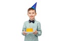 smiling boy in party hat with birthday cake Royalty Free Stock Photo