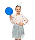 happy girl in birthday party hat blowing balloon Royalty Free Stock Photo