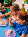 Birthday children celebrate party and eating cake on plate together . Royalty Free Stock Photo