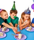 Birthday children celebrate party and eating cake on plate together. Royalty Free Stock Photo