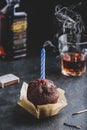Birthday chocolate muffin with smoking candle