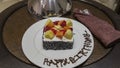 A birthday compliment. Sponge cake is decorated with cream and fruits
