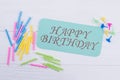 Birthday composition on white wooden background.