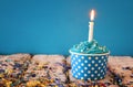 Birthday concept with cupcake and candle on wooden table Royalty Free Stock Photo