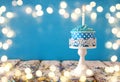 Birthday concept with cupcake and candle on wooden table Royalty Free Stock Photo