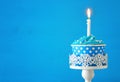 Birthday concept with cupcake and one candle on wooden table Royalty Free Stock Photo