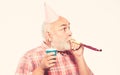 Birthday concept. Ideas for seniors birthday celebrations. Grandfather graybeard blowing party whistle. Getting older is