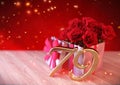 Birthday concept with red roses in gift on wooden desk. seventy-nineth. 79th.