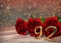 Birthday concept with red roses on wooden desk. ninety-second. 92nd. 3D render Royalty Free Stock Photo