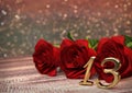 Birthday concept with red roses on wooden desk. thirteenth. 13th. 3D render Royalty Free Stock Photo