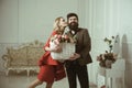 Birthday concept. Sensual woman kiss bearded man with birthday flowers. Bearded man give basket with flowers to woman on