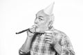 Birthday crazy party. Ideas seniors birthday celebrations. Grandfather graybeard blowing party whistle. Getting older is