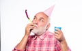 Birthday crazy party. Ideas seniors birthday celebrations. Elderly people. Man bearded grandpa with birthday cap and Royalty Free Stock Photo