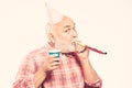 Birthday crazy party. Ideas seniors birthday celebrations. Grandfather graybeard blowing party whistle. Getting older is Royalty Free Stock Photo