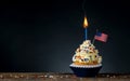 Birthday cupcake. American Flag. Burning candle light in a cake. 4th of July, Independence, Memorial or Presidents Day.