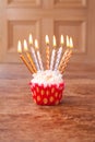 Birthday cupcake blurry background with lots of lit candles Royalty Free Stock Photo