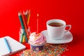 Birthday cupcake on brigth red background