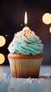 Birthday cupcake with burning candle, closeup, light background