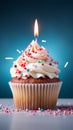 Birthday cupcake with burning candle, closeup, light background