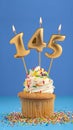 Birthday cupcake with candle number 145 - Blue background