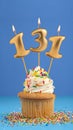 Birthday cupcake with candle number 131 - Blue background