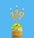 Birthday cupcake with candle number 119 - Blue background Royalty Free Stock Photo