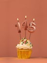 Birthday cupcake with candle number 145 - Coral fusion background