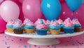 birthday cupcake Birthday cupcakes with pink and blue frosting and sprinkles on a white cake stand. Royalty Free Stock Photo