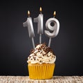 birthday cupcake with number 119 candle - Celebration on dark background Royalty Free Stock Photo