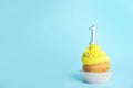 Birthday cupcake with number one candle on blue background Royalty Free Stock Photo