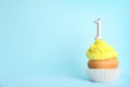 Birthday cupcake with number one  on blue background, space for text Royalty Free Stock Photo