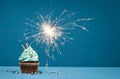 Birthday Cupcake with sparkler on a blue background Royalty Free Stock Photo