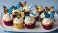 birthday cupcakes Cupcakes with cream and sugar butterflies and birthday candles on a white plate. The cupcakes have butterflies Royalty Free Stock Photo