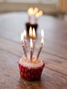 Birthday cupcakes with lots of lit candles Royalty Free Stock Photo