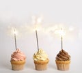 Birthday cupcakes with sparklers on background Royalty Free Stock Photo