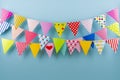 Birthday fest garlands from colorful triangular flags on blue background Royalty Free Stock Photo