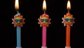 Birthday festive candles in form of sun in sunglasses isolated on black background Royalty Free Stock Photo