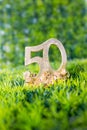 birthday or fifty anniversary in golden numbers on green grass