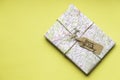 Birthday gift in nice vintage wrapping on yellow background